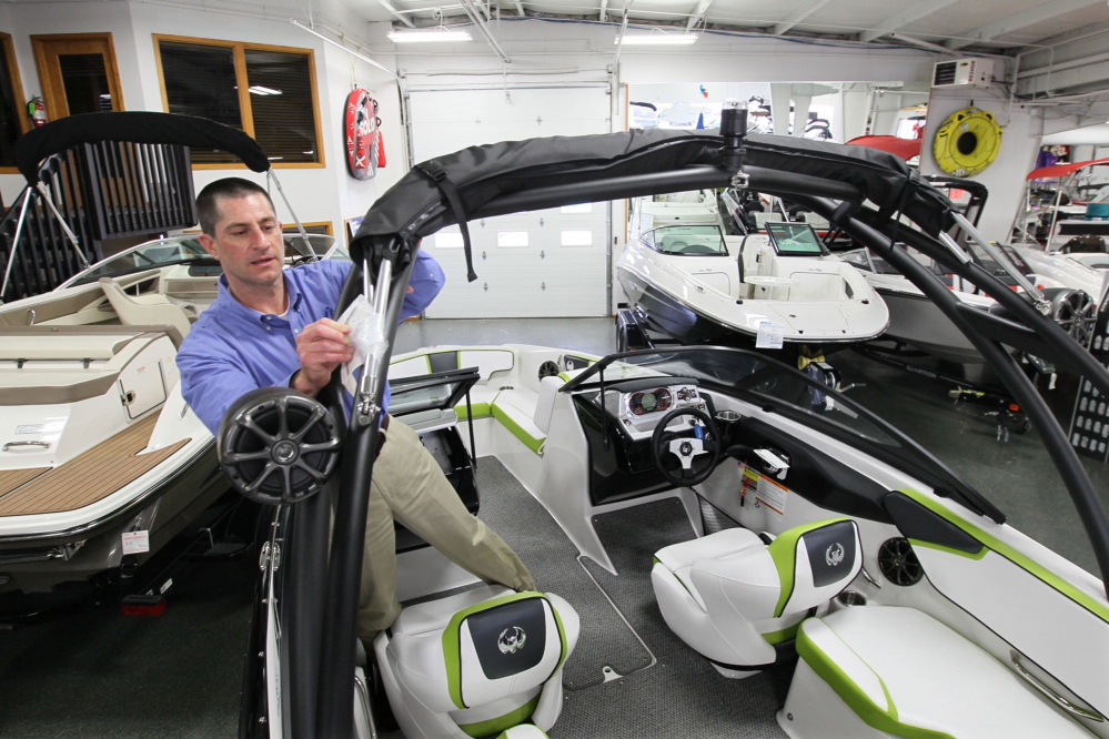Todd Riepe gets a Scarab jet boat ready for sale at SkipperBud’s boat dealership in Pewaukee, Wis. Boat builders are trying to give consumers the content they want without having hundreds of options, which add to a company’s costs.