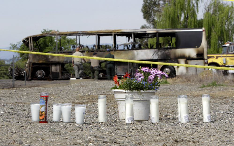 A makeshift memorial is created for the victims of an accident that included a tour bus and a FedEx truck on Interstate 5 in Orland, Calif.