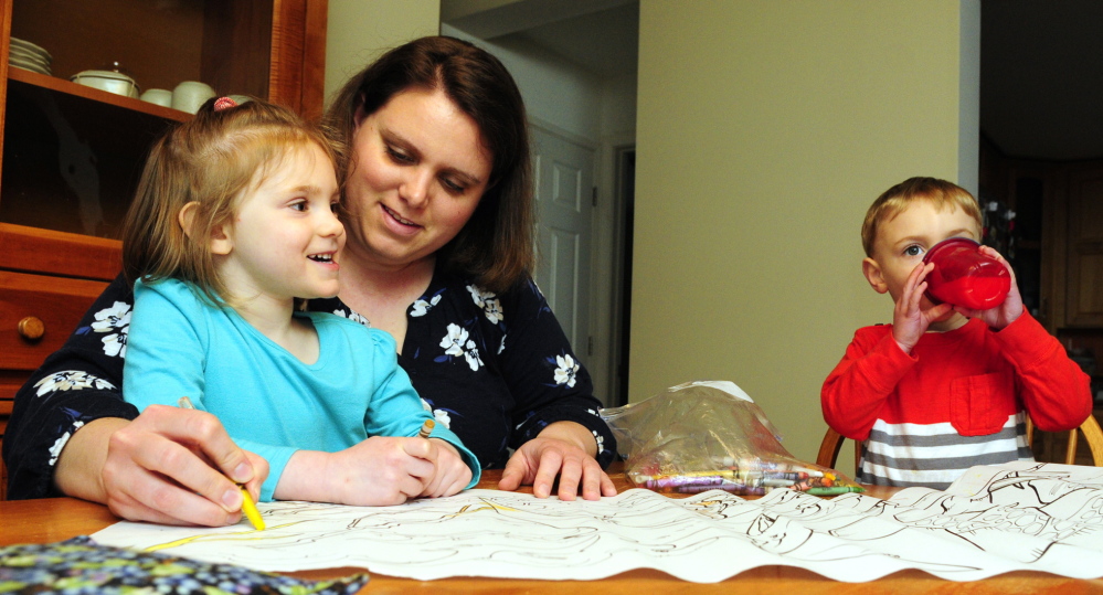 Emily Roderick colors with her children Annalise, 3, left, and Austin, 2, on Tuesday in Readfield. She plans to have her well tested frequently for arsenic in the water.