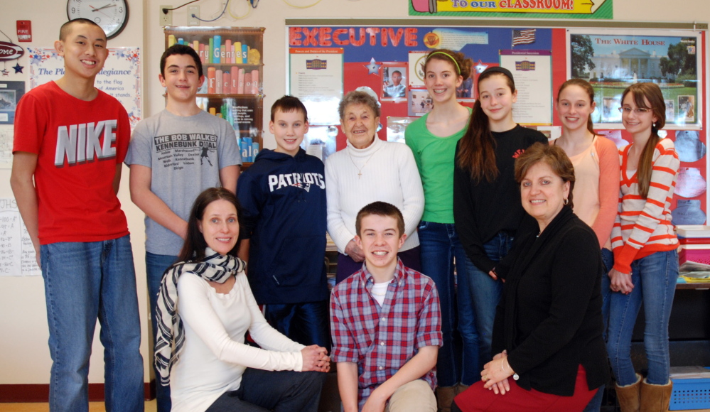 Members of the Wells Junior High School Newspaper Club donated $225 to the St. Mary’s Food Pantry. Pictured (back row, from left) are Channing Wang, Nolan Potter, Kyle Crothers, Pantry Director Elinor Grover, Megan Schneider, Olivia Durfee, Madison Szczygiel, Paige Raymond and, front row center, Christian Saulnier. Flanking Saulnier are teachers Julie Esch and Marilyn Zotos.