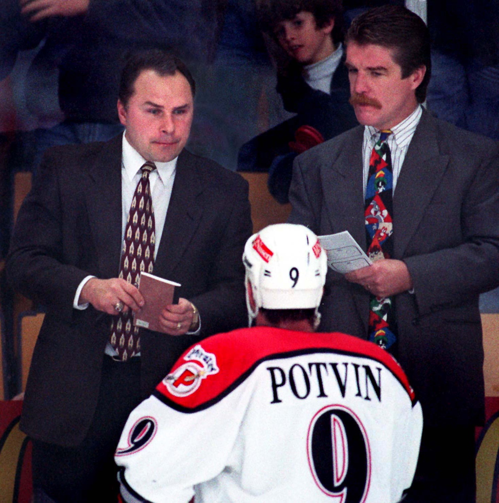 STAFF PHOTO BY GORDON CHIBROSKI -- Thursday, October 24, 1996 -- Barry Trotz, Portland Pirates' coach, and assistant coach Paul Gardner, listen to Marc Potvin's concerns during a game at the CCCC.