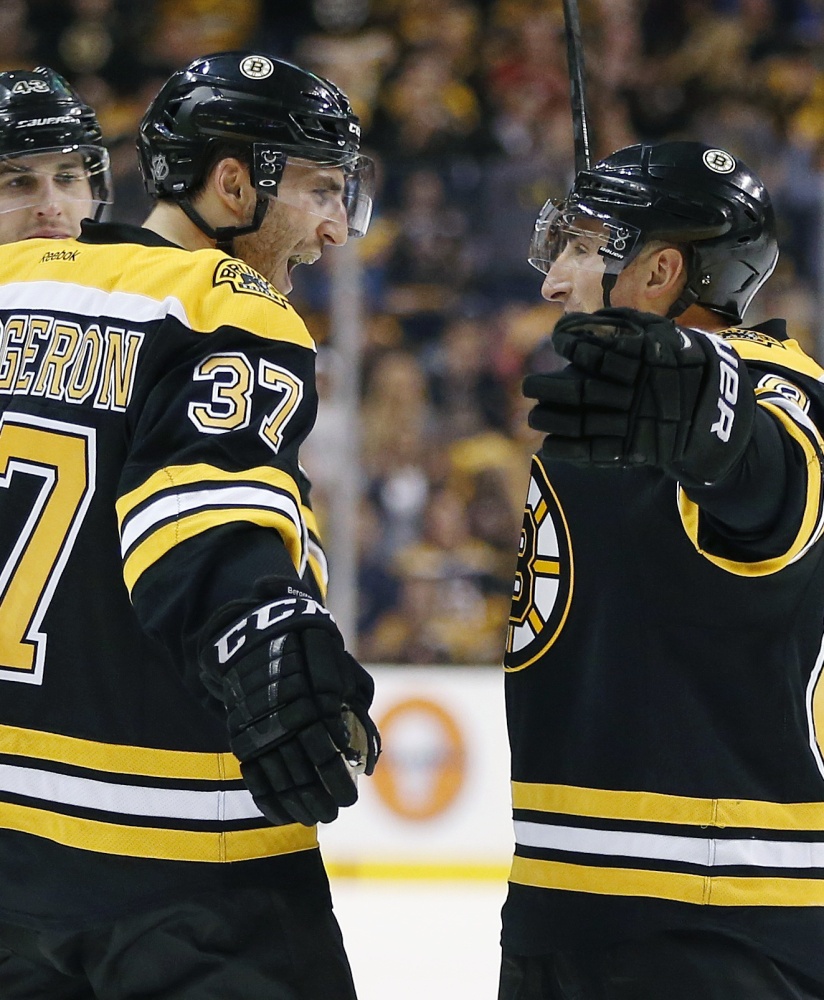 Boston faces Detroit on Friday, but Patrice Bergeron, left, and Brad Marchand are part of a Bruins team loaded with postseason experience.