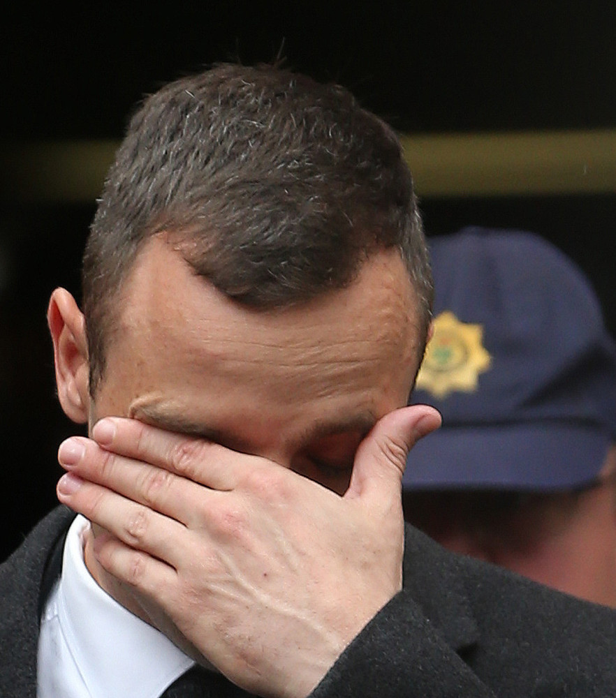 Oscar Pistorius, leaves the high court in Pretoria, South Africa, Monday. He is charged with murder in the shooting death of his girlfriend.