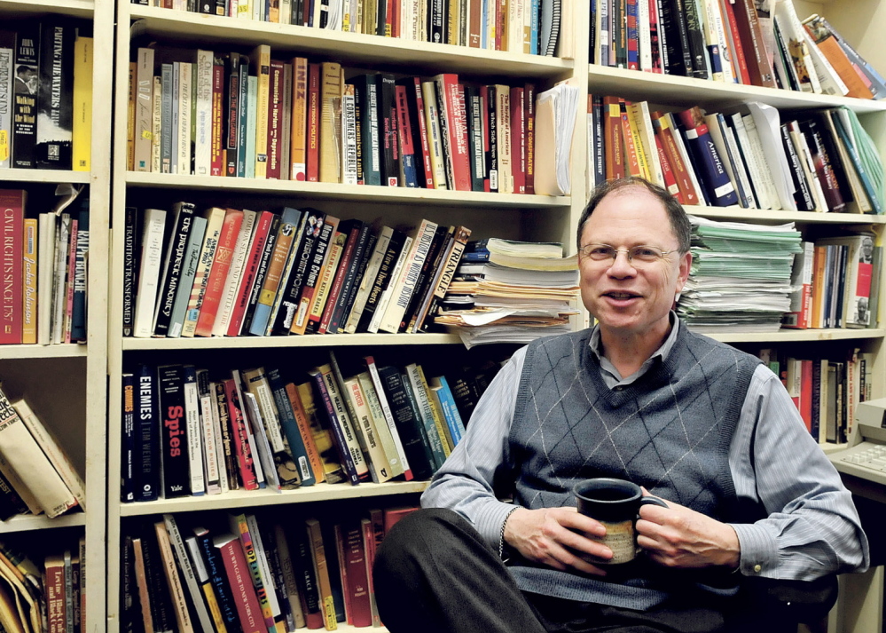 Robert Weisbrot, Colby College history professor, in his office in Waterville on Monday says the loss of hard copies of books arranged in library stacks hurts teaching and research.