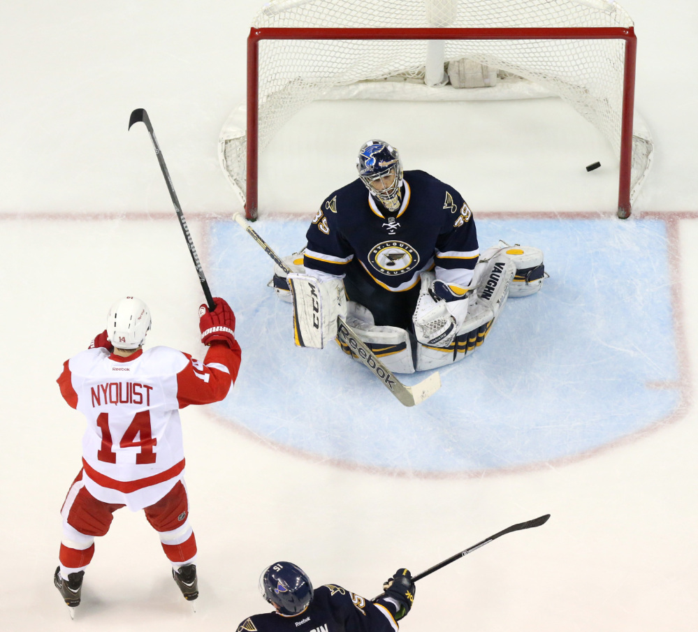 Detroit’s Gustav Nyquist, left, raises his stick after teammate Justin Abdelkader scored against St. Louis Blues goaltender Ryan Miller during the third period of Detroit’s 3-0 win at St. Louis on Sunday. Nyquist and Abdelkader powered a charge into the playoffs.
