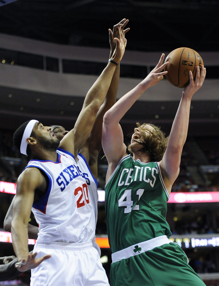Boston’s Kelly Olynyk goes up for a shot against Brandon Davies of the 76ers during the Celtics’ 113-108 loss at Philadelphia on Monday. Olynyk led Boston with 28 points.