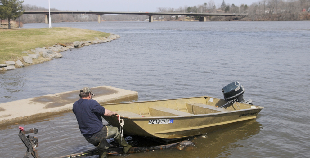 Kevin Lemar of Belfast hitches his vessel to a trailer Monday at the boat landing on the Kennebec River in Gardiner. Lemar, who was fishing for suckers, said conditions on the Kennebec were unpredictable. “Year after year, it’s always different,” Lemar said.
