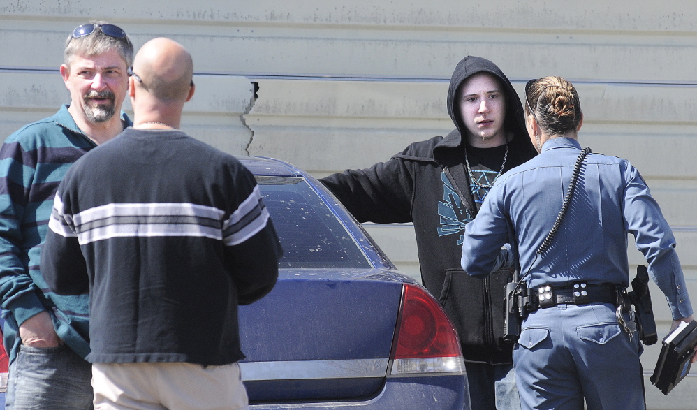 Fred Horne Sr., left, and Fred Horne Jr. speak with state police troopers Thursday after being charged with sex trafficking at their Sidney residence. The two were evicted from a North Belgrade house last June when the landlord suspected similar activity, according to affidavits on the case released Tuesday.