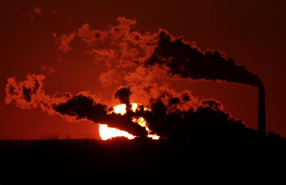 Steam from the Jeffrey Energy Center coal-fired power plant is silhouetted against the setting sun as the facility generates power last month near St. Marys, Kan. A federal appeals court Tuesday upheld the Environmental Protection Agency’s emission standards for a variety of pollutants.