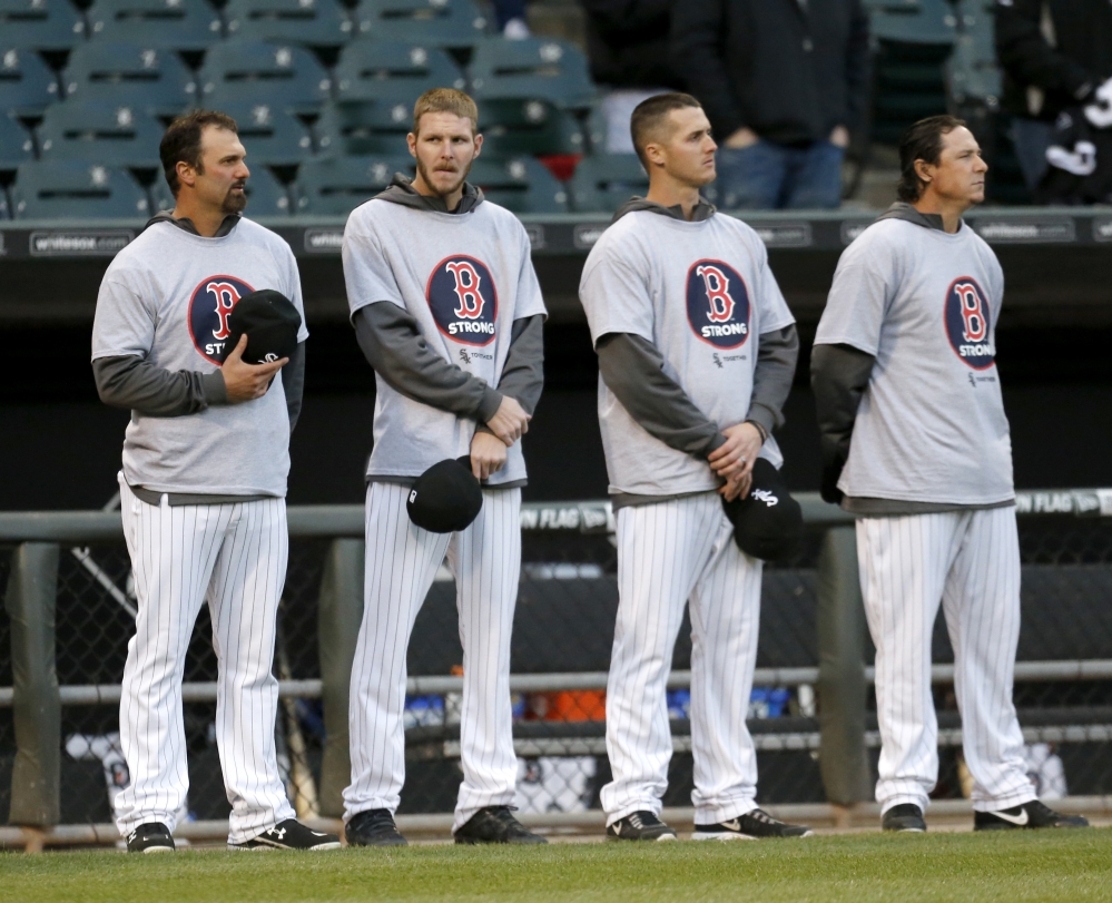 Members of the Chicago White Sox, from left, Paul Konerko, Chris Sale, Nate Jones, and Scott Downs stand wearing Boston Strong shirts before the game against Boston on Tuesday.
