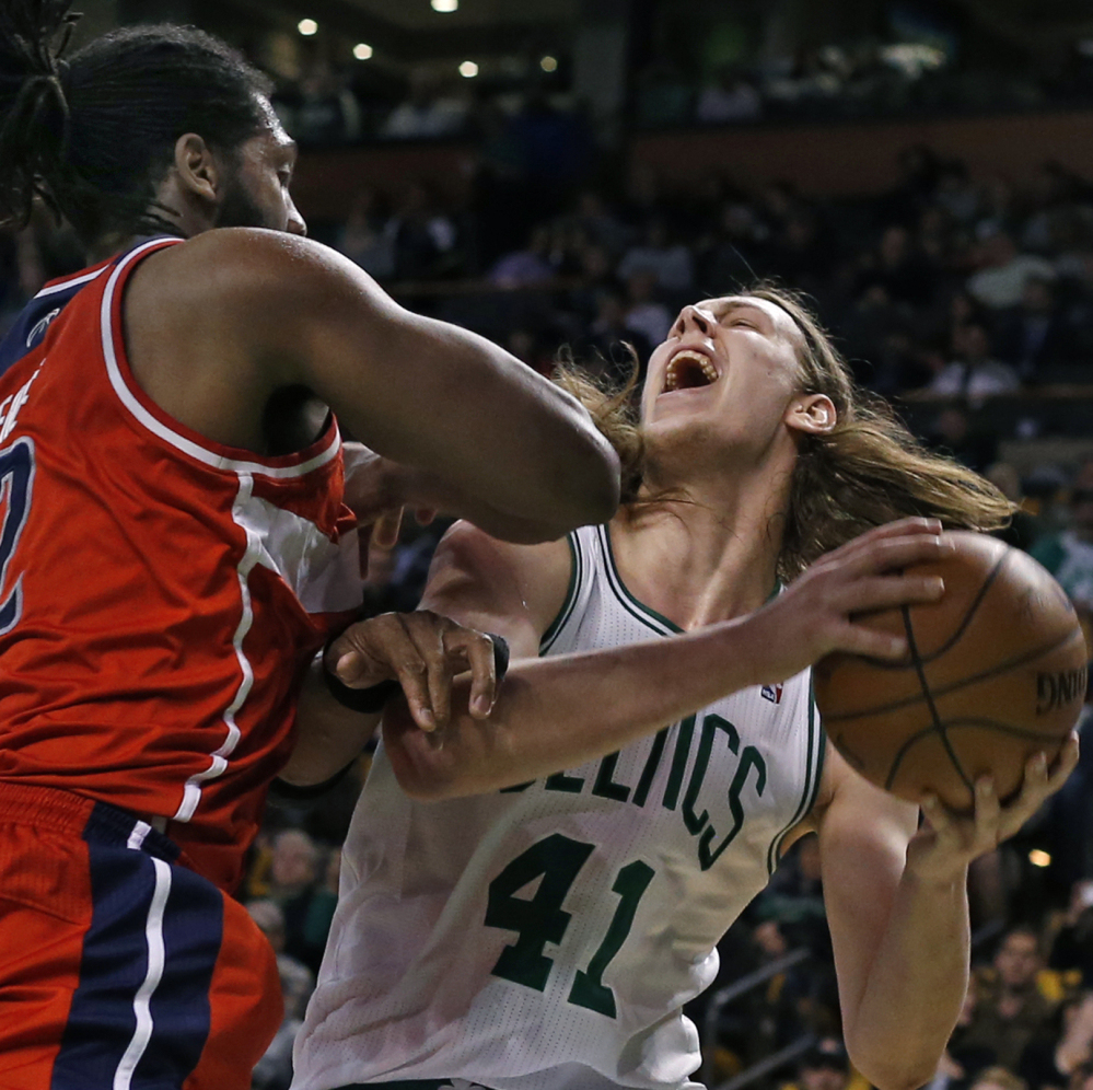 Celtics rookie center Kelly Olynyk goes up to shoot against Washington’s Nene Hilario in Wednesday’s game at Boston. The Celtics finished the season 25-57.