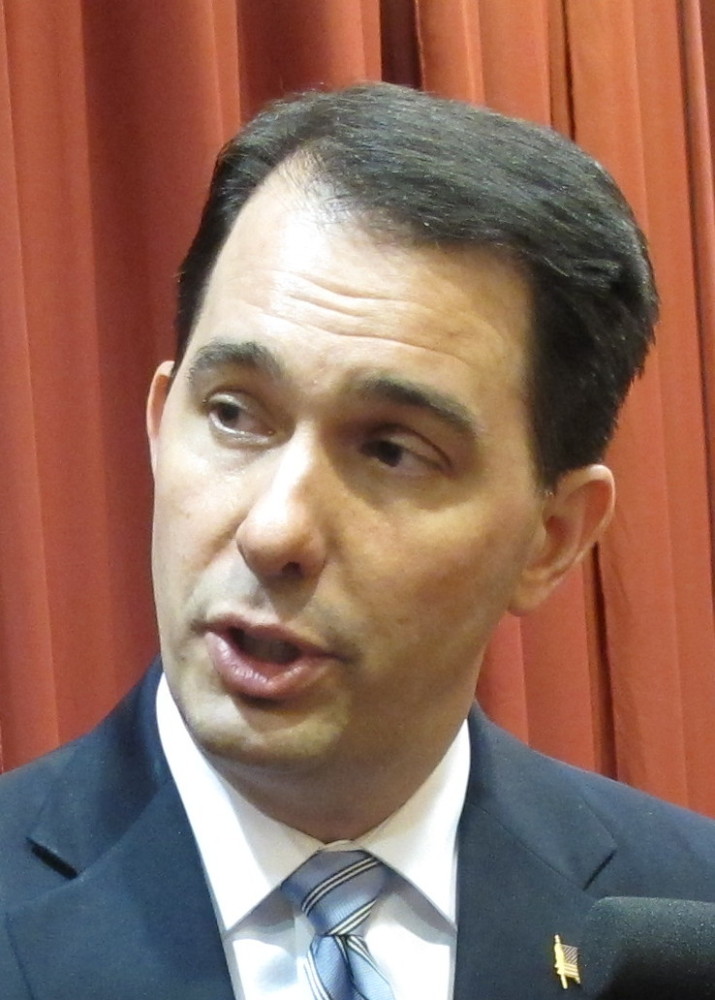 Wisconsin Gov. Scott Walker answers questions from reporters on Wednesday in Madison, Wis. Liberal rocker John Mellencamp wants conservative Republican Gov. Walker to know he supports union rights and says Walker should think about that before using his songs on the campaign trail.