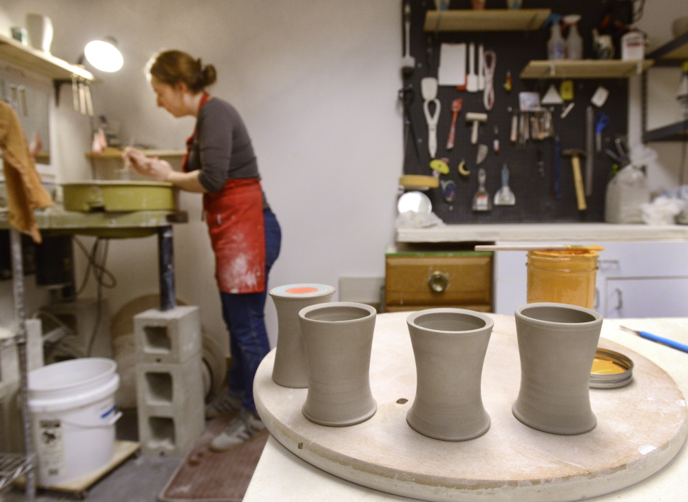 Artist Megan Walsh makes tumblers in studio space at the latest home of the Running With Scissors collective on Anderson Street in Portland. The building has kilns, work tables and wheels for a dozen potters, as well as a print shop, a wood shop, classroom space, a small library and light tables.