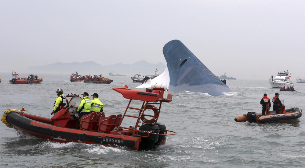 South Korean coast guard officers and rescue team members try to rescue passengers from the ferry Sewol in the water off the southern coast near Jindo, south of Seoul, on Wednesday.