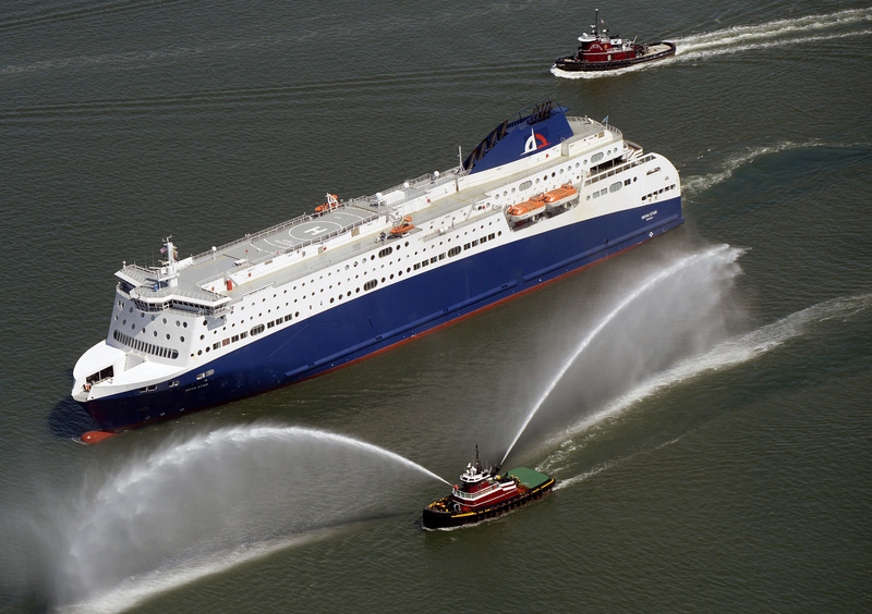 A tugboat gushes dual fountains of water in greeting as the Nova Star ferry cruises into Portland Harbor on Thursday. The ferry will be christened in Boston on May 12.
