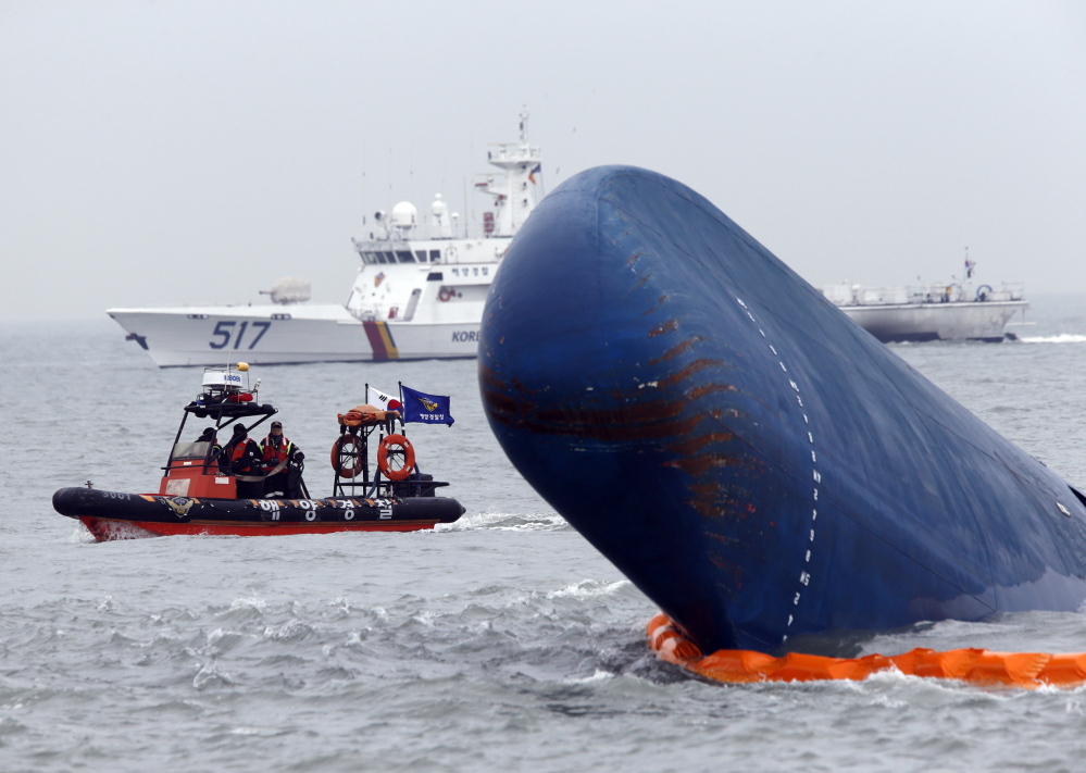 Boats sail around the South Korean passenger ship Sewol during their rescue operation in the sea off Jindo on Thursday, after the ferry capsized in sight of land.