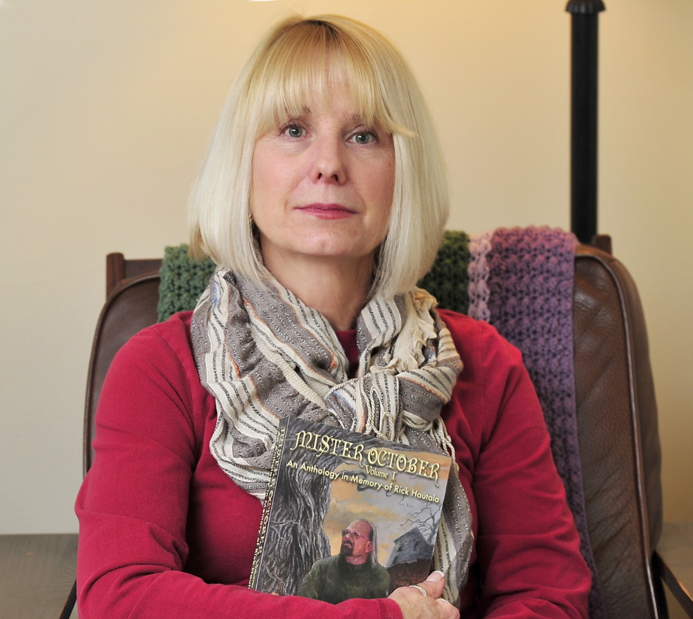 Holly Newstein, holding a book about her late husband, the Westbrook author Rick Hautala, is disappointed that the author’s hometown library would not accept his archives.