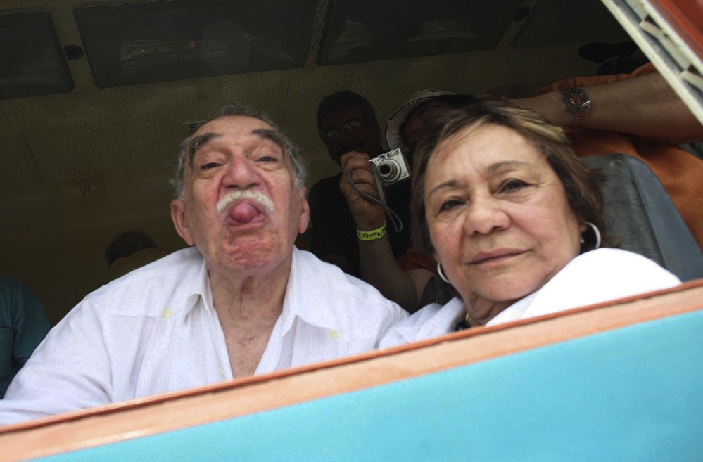 In this May 2007 file photo, Colombia’s Literature Nobel Prize winner Gabriel Garcia Marquez sticks out his tongue to photographers as he arrives on a train to Aracataca, his hometown in northeastern Colombia. At right is his wife Mercedes Barcha who accompanied the writer on his first visit to his hometown in 25 years. Marquez died Thursday April 17, 2014 at his home in Mexico City.