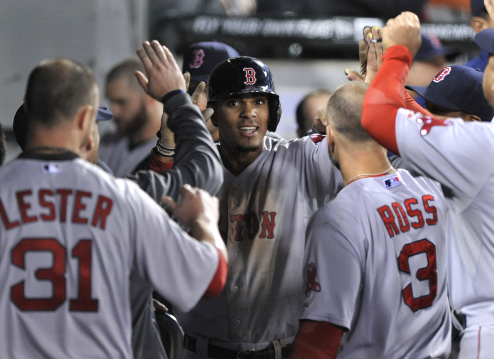 Xander Bogaerts celebrates with his Red Sox teammates in the dugout after hitting a solo home run in the sixth inning against the Chicago White Sox in Chicago on Thursday.