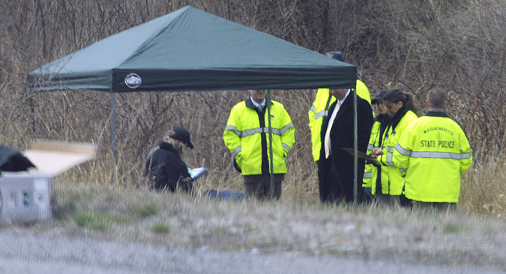 Massachusetts State Police stand along Interstate 190 near Sterling, where a child’s body was found Friday. Jeremiah Oliver of Fitchburg has been missing since September.