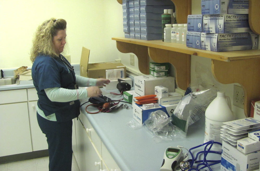 Tammy Holt, a medical assistant with Portland Community Health Center, unpacks medical supplies Friday at the center’s new health clinic for the homeless at 63 Preble St. in Portland. The clinic will open officially Tuesday.
