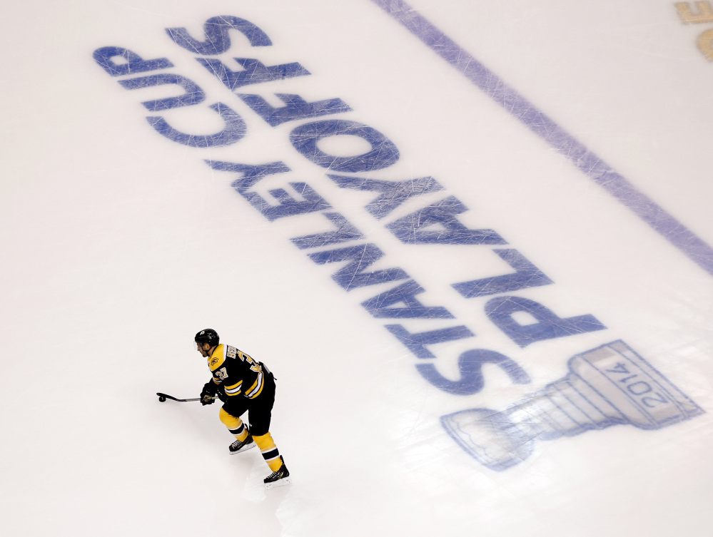 Boston Bruins’ Patrice Bergeron warms up for Game 1 of a first-round NHL playoff hockey series against the Detroit Red Wings in Boston on Friday, April 18, 2014.