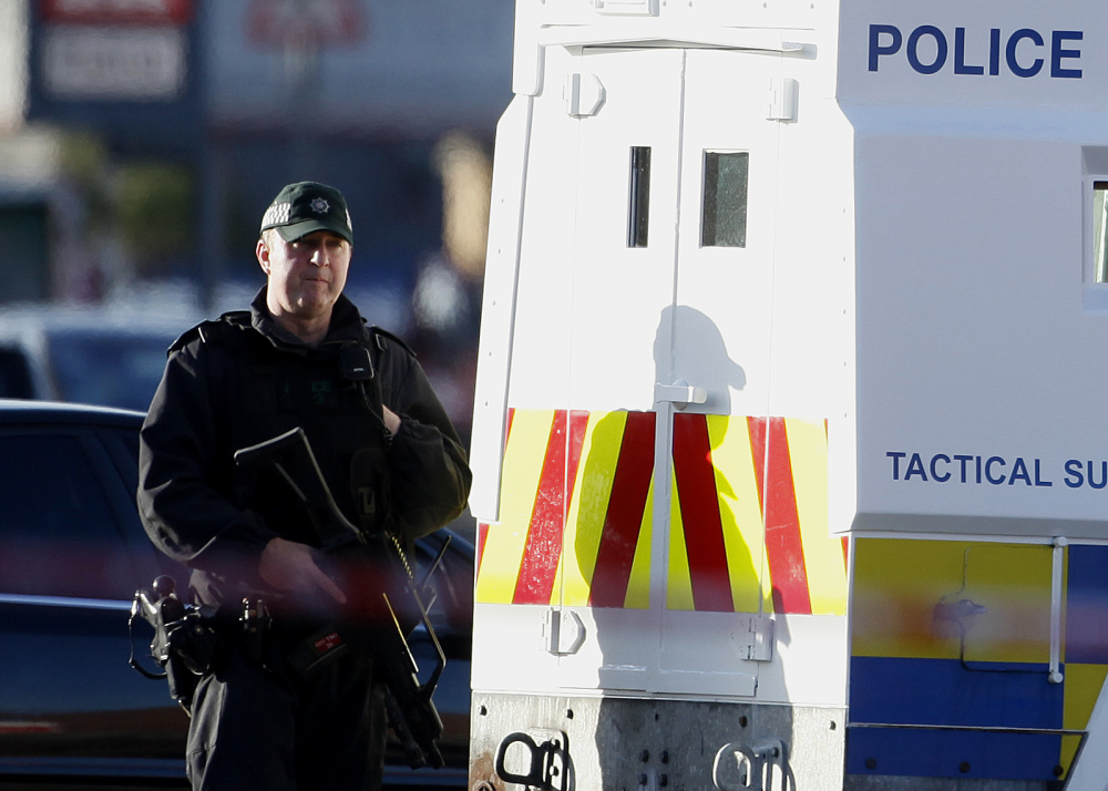 A police officer patrols the area close to where Tommy Crossan, a senior Irish Republican Army hard-liner, was shot dead Friday in Belfast, Northern Ireland.