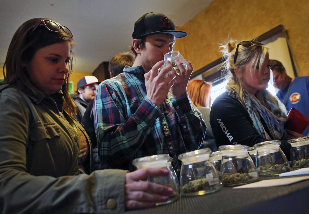 Customers shop for marijuana Friday in Denver. Two recent deaths have raised concerns about Colorado’s recreational marijuana industry and the effects of the drug, since cookies, candy and other edibles can be exponentially more potent than a joint.
