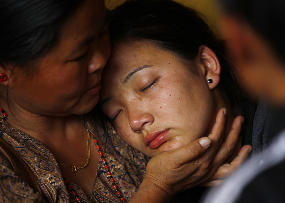 A daughter of a Nepalese mountaineer who was killed in Friday’s avalanche on Mount Everest cries as her father’s body arrives at a Katmandu monastery.