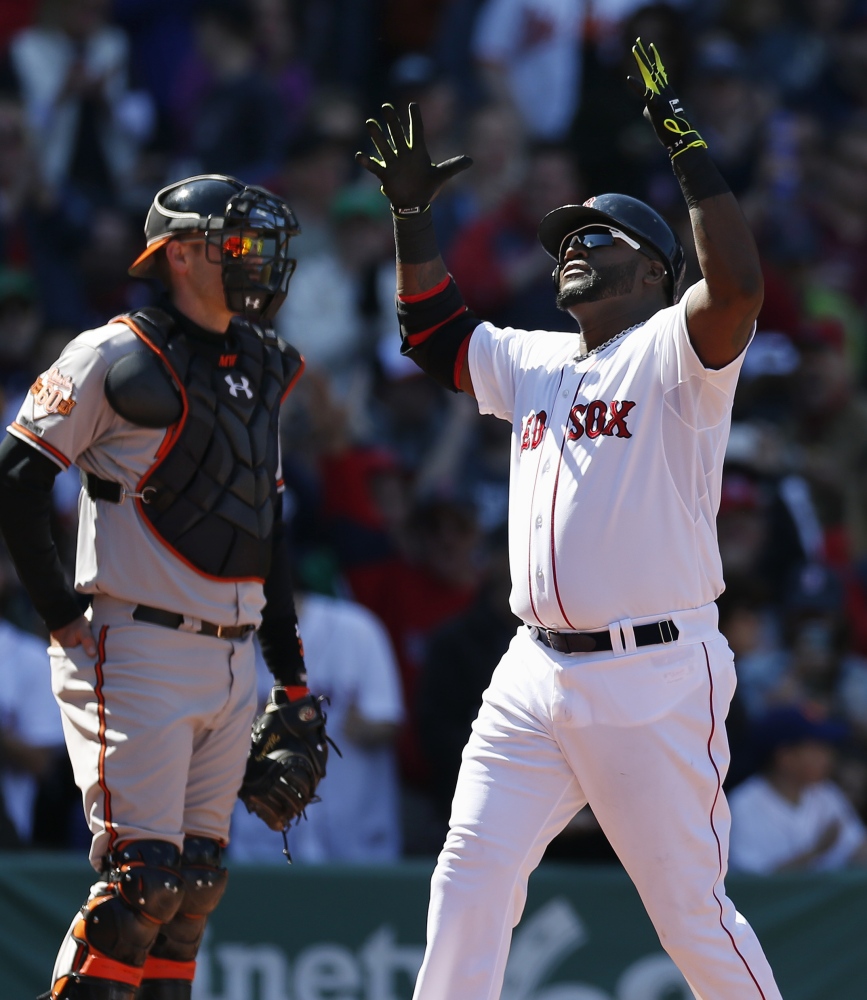 Boston Red Sox’s David Ortiz celebrates his home run in front of Baltimore Orioles’ Matt Wieters in the fourth inning of Saturday’s game.