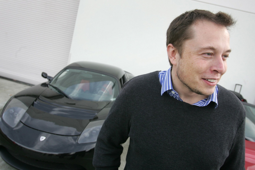 Tesla Chairman Elon Musk poses with Tesla prototypes parked in the background. With SpaceX, the rocket company he founded in 2002, Musk hopes to employ recyclable rockets to send humans into space and one day build settlements on Mars.