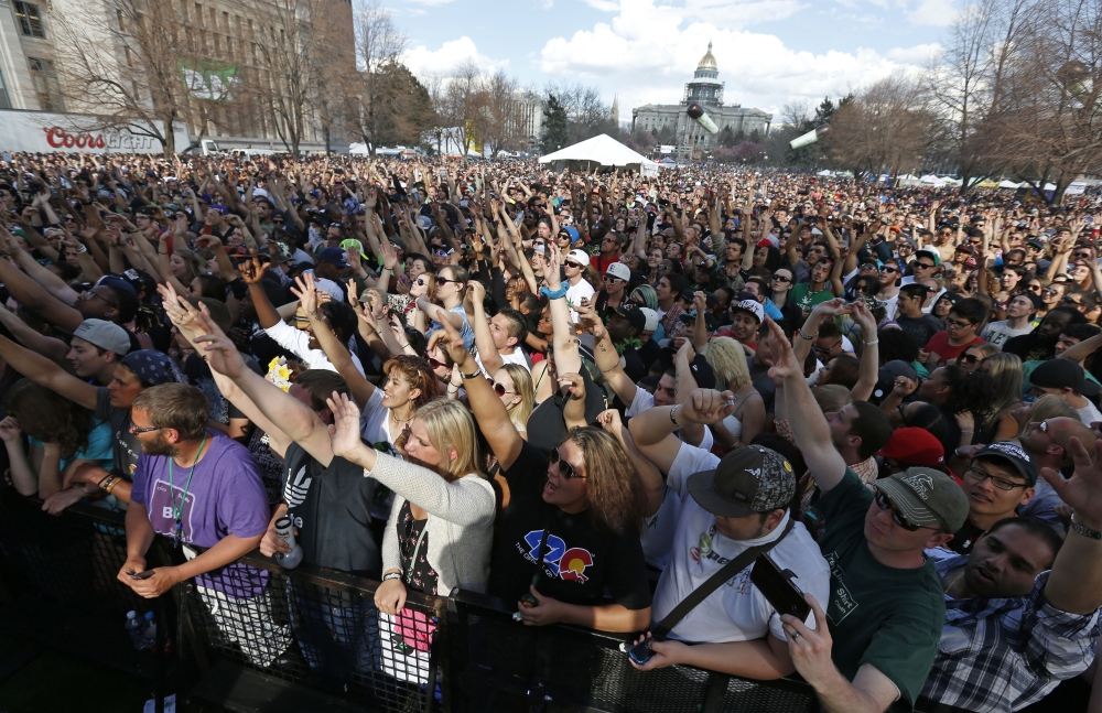 Partygoers listen to live music on the second of two days at the annual 4/20 marijuana festival in Denver, Sunday.