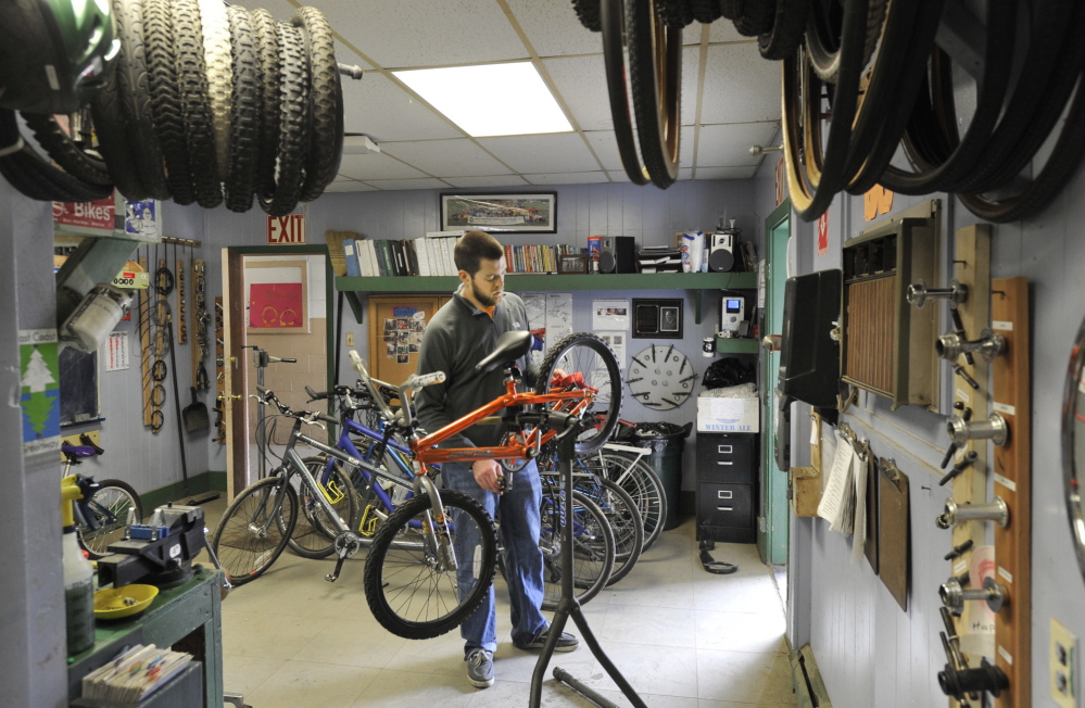 Andrew Burnell works on a bike at the Community Bicycle Center on Hill Street in Biddeford. The program has served more than 1,100 kids since it started eight years ago. Its new location will accommodate more participants and expanded programming.