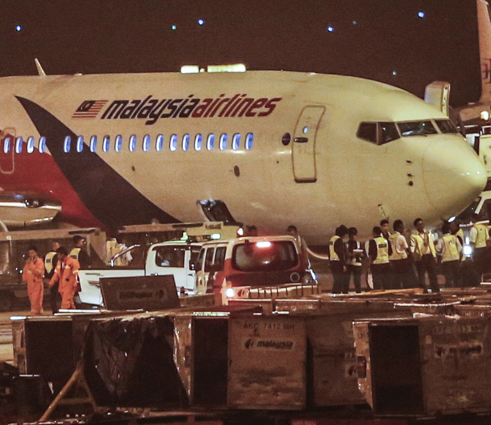 The ground crew checks the Malaysia Airlines Flight 192 bound for Bangalore, India, that turned back to Kuala Lumpur International Airport in Sepang, Malaysia, on Monday.