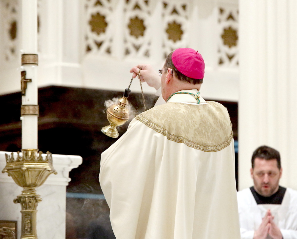 Most Rev. Robert P. Deeley, bishop of the Roman Catholic Diocese of Portland, uses incense near the altar during Easter Mass at the Cathedral of the Immaculate Conception in Portland on Sunday morning.