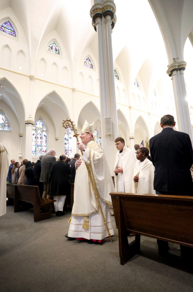 Most Rev. Robert P. Deeley, bishop of the Roman Catholic Diocese of Portland, walks in the procession during Easter Mass at the Cathedral of the Immaculate Conception in Portland on Sunday morning.