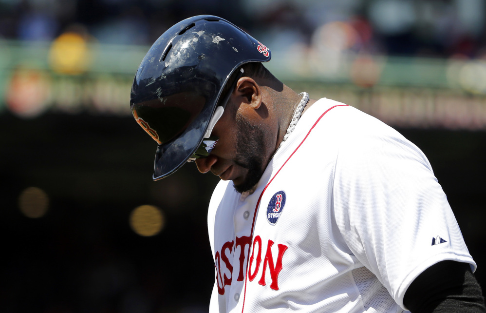 Red Sox designated hitter David Ortiz heads back to the dugout after lining out to end the fifth inning against the Orioles at Fenway Park on Monday.