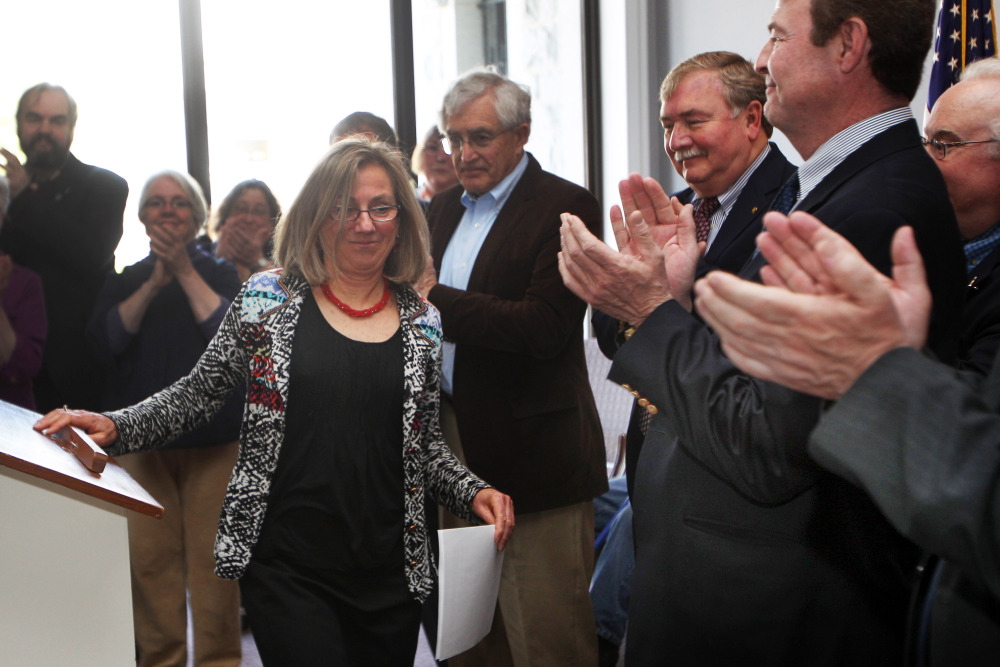 New Hampshire’s first Democratic House speaker in 84 years, Terie Norelli, center, is applauded by supporters following a news conference Monday in Concord, N.H.