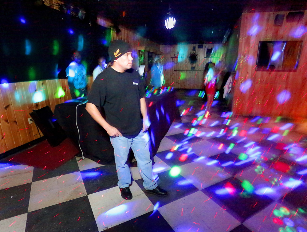Allen Moore, owner of Skybox Bar & Grill in Westbrook, stands on the dance floor before a show April 18.