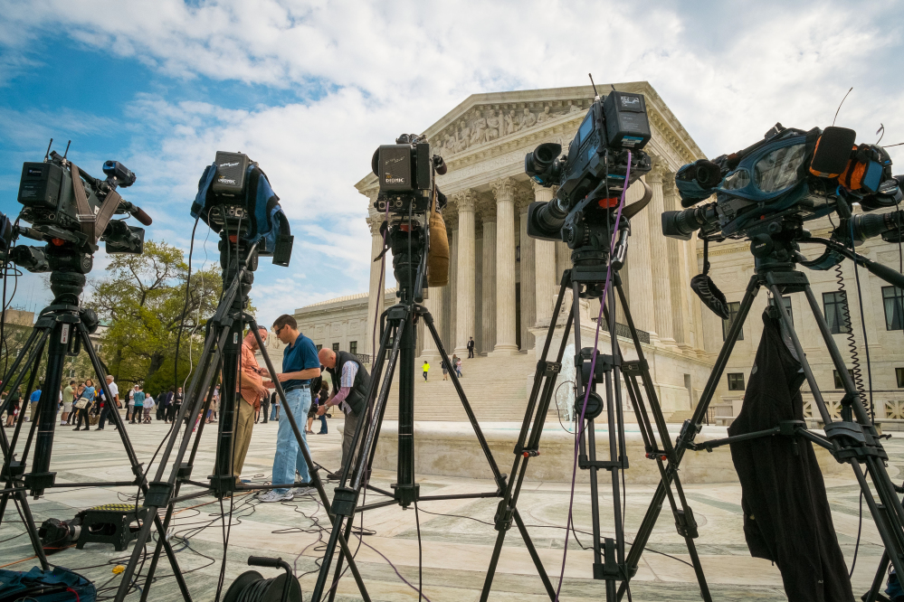 Videojournalists set up outside of the Supreme Court in Washington on Tuesday. The court heard arguments between TV broadcasters and Aereo Inc., a startup that gives subscribers Internet access to broadcast television.