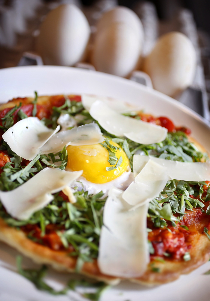 A pizza topped by a fried duck egg prepared by executive chef Pete Sueltenfuss at Grace in Portland.