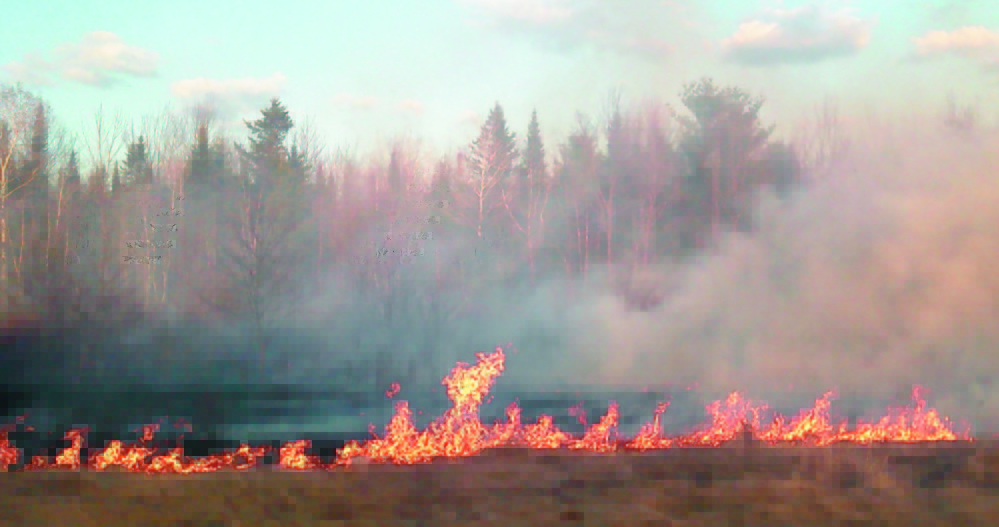 A Clinton wildfire shown in this April 2012 photo burned about 6 acres of grass and brush before it was contained.