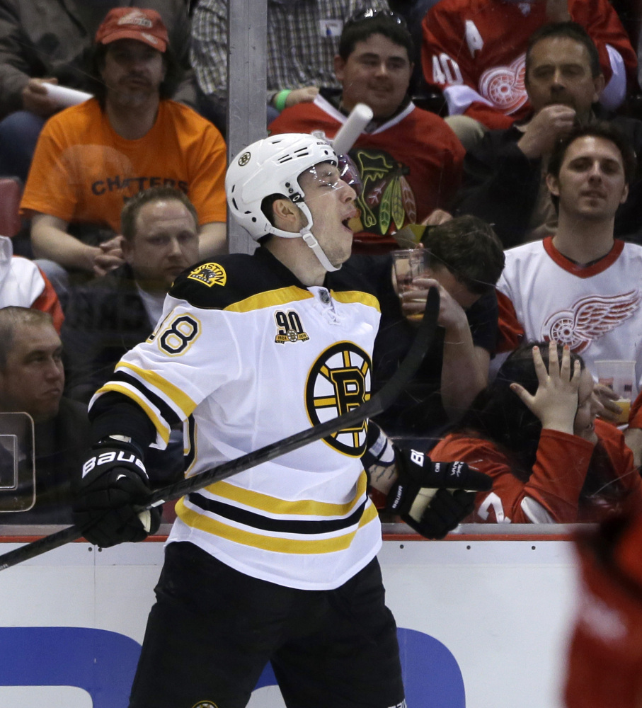 Boston Bruins left wing Jordan Caron (38) celebrates his goal during the first period of Game 3 of a first-round NHL hockey playoff series against the Detroit Red Wings in Detroit, Tuesday, April 22, 2014.