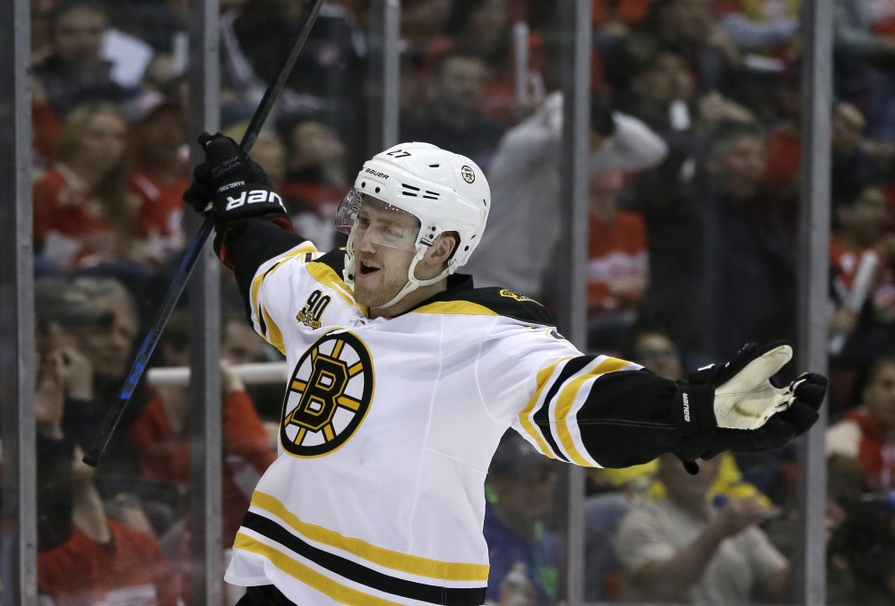 Boston Bruins defenseman Dougie Hamilton reacts after scoring during the first period of Game 3 of a first-round NHL hockey playoff series against the Detroit Red Wings in Detroit, Tuesday, April 22, 2014.