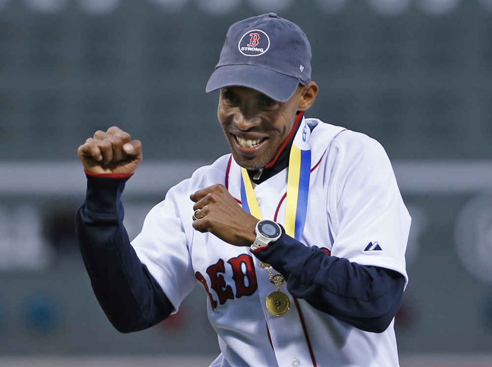 Meb Keflezighi, men’s winner of this week’s Boston Marathon, reacts after throwing the ceremonial first pitch at Fenway Park on Wednesday.