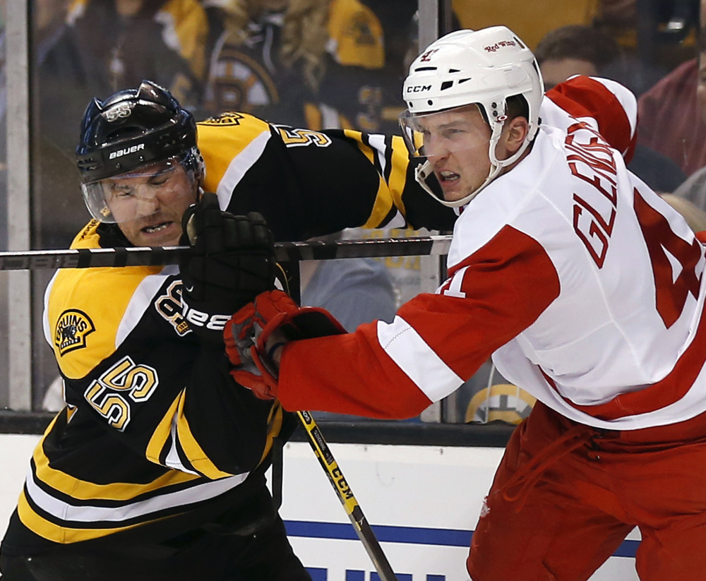 Johnny Boychuk, left, and the Boston defense has been able to shut down Luke Glendening and the high-scoring Red Wings through three games.