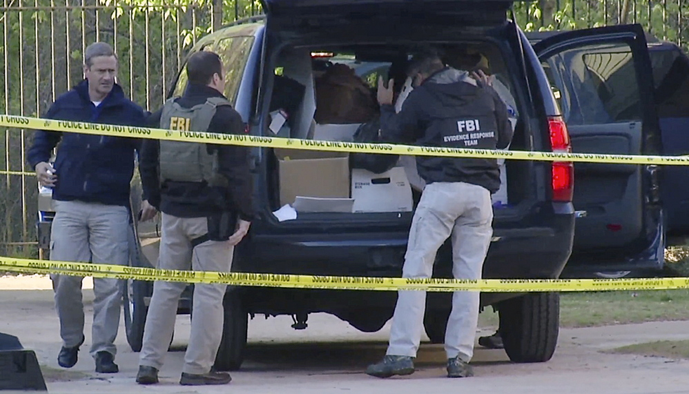 FBI agents collect evidence at an apartment complex on April 10 in Atlanta, Ga., where federal agents rescued kidnap victim Frank Arthur Janssen of Wake Forest. N.C.