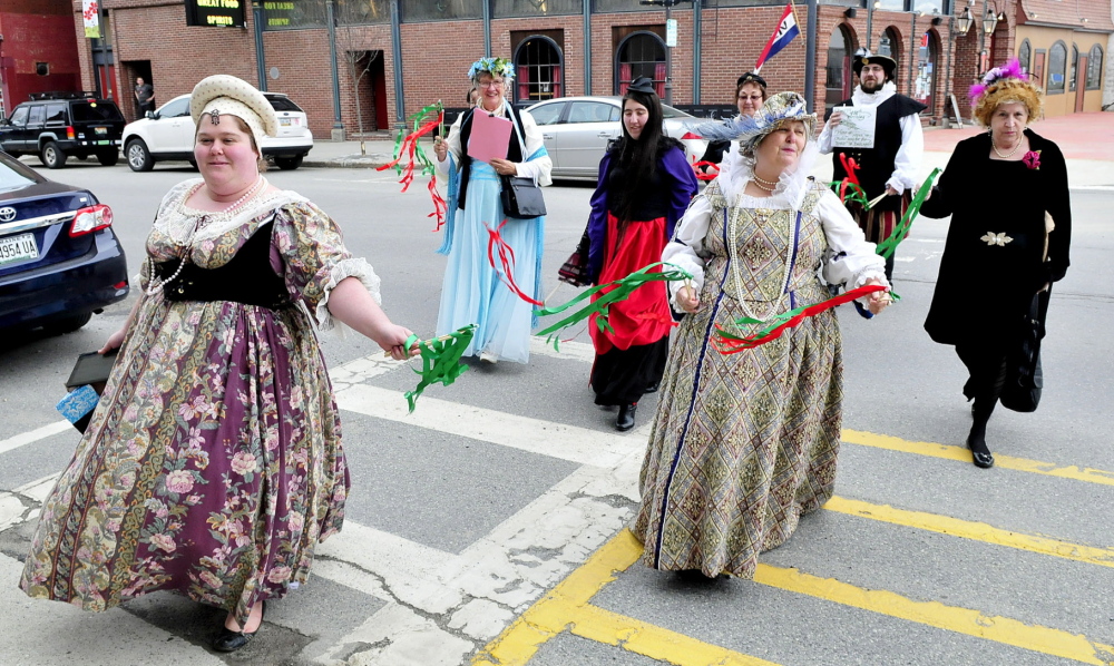 Dressed in period outfits, a group from the Recycled Shakespeare Company crosses Main Street in downtown Waterville on Wednesday during a celebration of William Shakespeare’s 450th birthday. Leading the group are Emily Rowden Fournier, left, and her mother, Lyn Rowden, who was dressed as Queen Elizabeth I.