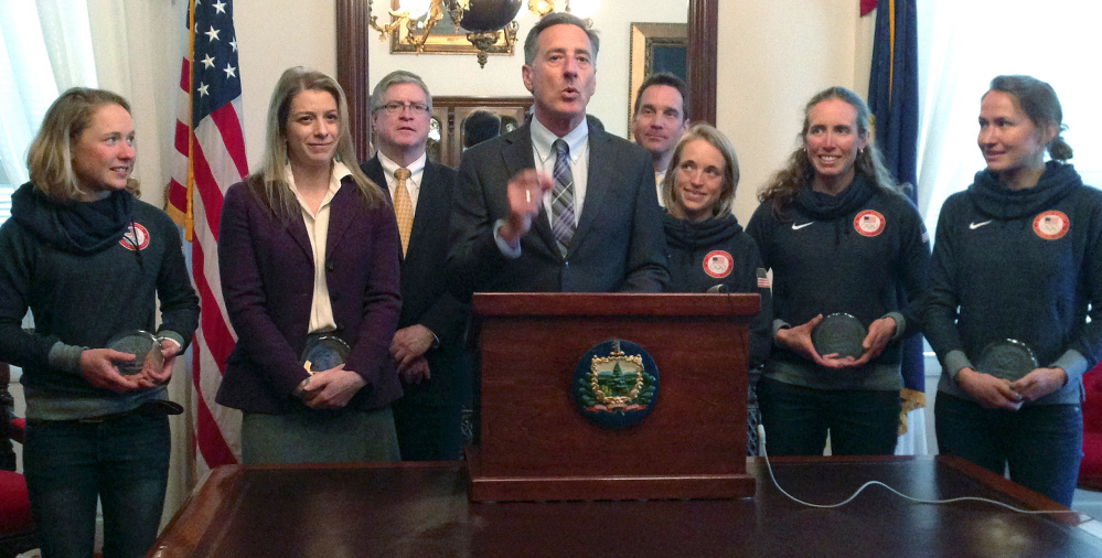 Vermont Gov. Shumlin, center, speaks Wednesday at a ceremony in Montpelier, honoring athletes from his state who participated in the Winter Olympics in Sochi. Five Olympians are, from left, Ida Sargeant, Hannah Kearney, Liz Stephen, Susan Dunklee and Sophie Caldwell. At rear are state Senate President Pro Tem John Campbell, left, and Parker Riehle, president of the Vermont Ski Areas Association.