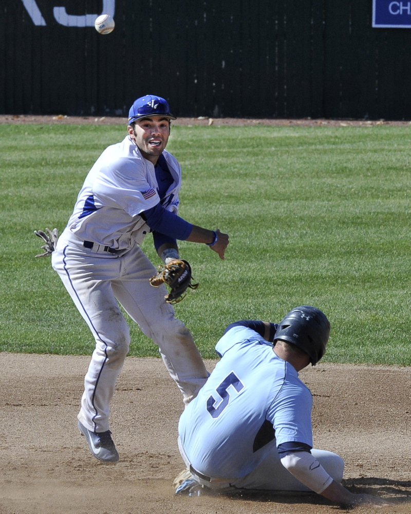 Zach Graham of St. Joseph’s makes an attempt for a double play after forcing Chris Pittman at second base. The throw was late but no matter, the Monks advanced at home in the four-team, double-elimination tournament.